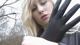 cute-girl-putting-on-leather-gloves-woods